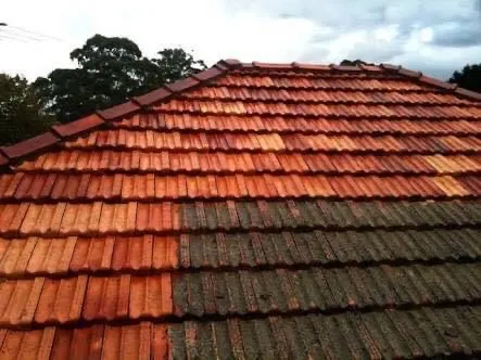 in progress, a tiled roof being professio0anlly pressure cleaned 